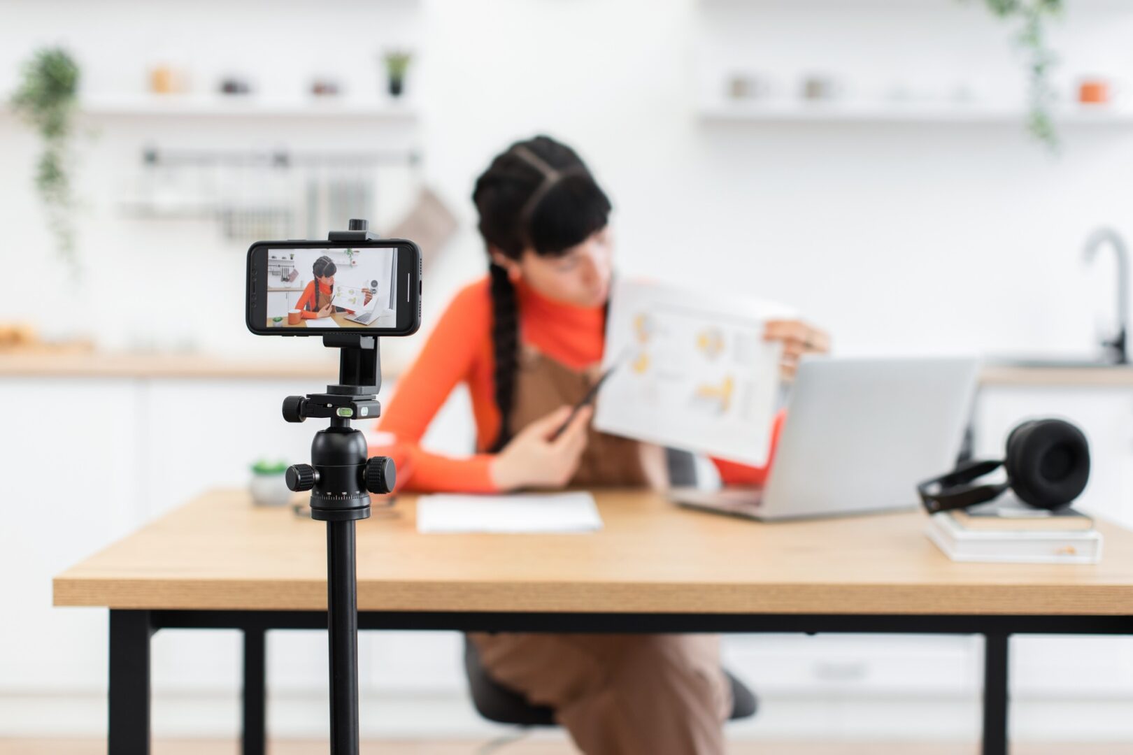 Caucasian woman influencer filming educational content with smartphone